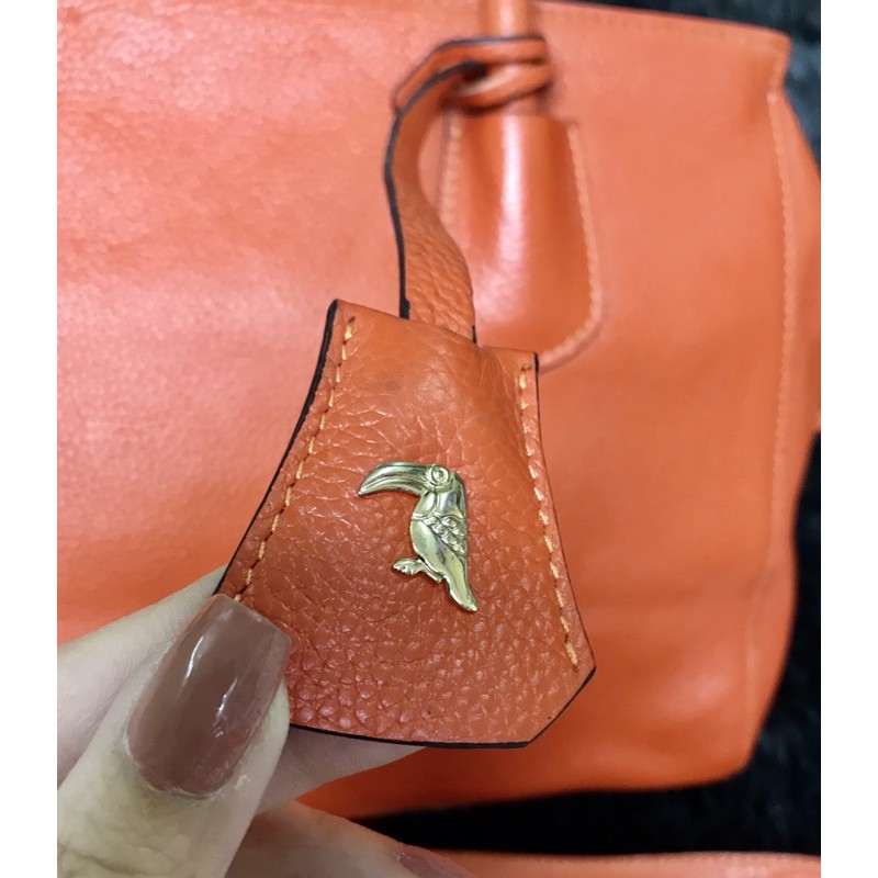 👜  Túi cầm tay, đeo chéo da thật màu cam hiệu Tucano