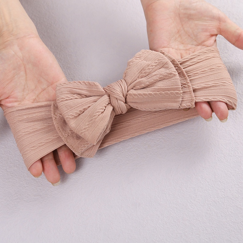 Băng đô thắt nơ chất liệu nylon co giãn mềm mại màu trơn dành cho bé gái