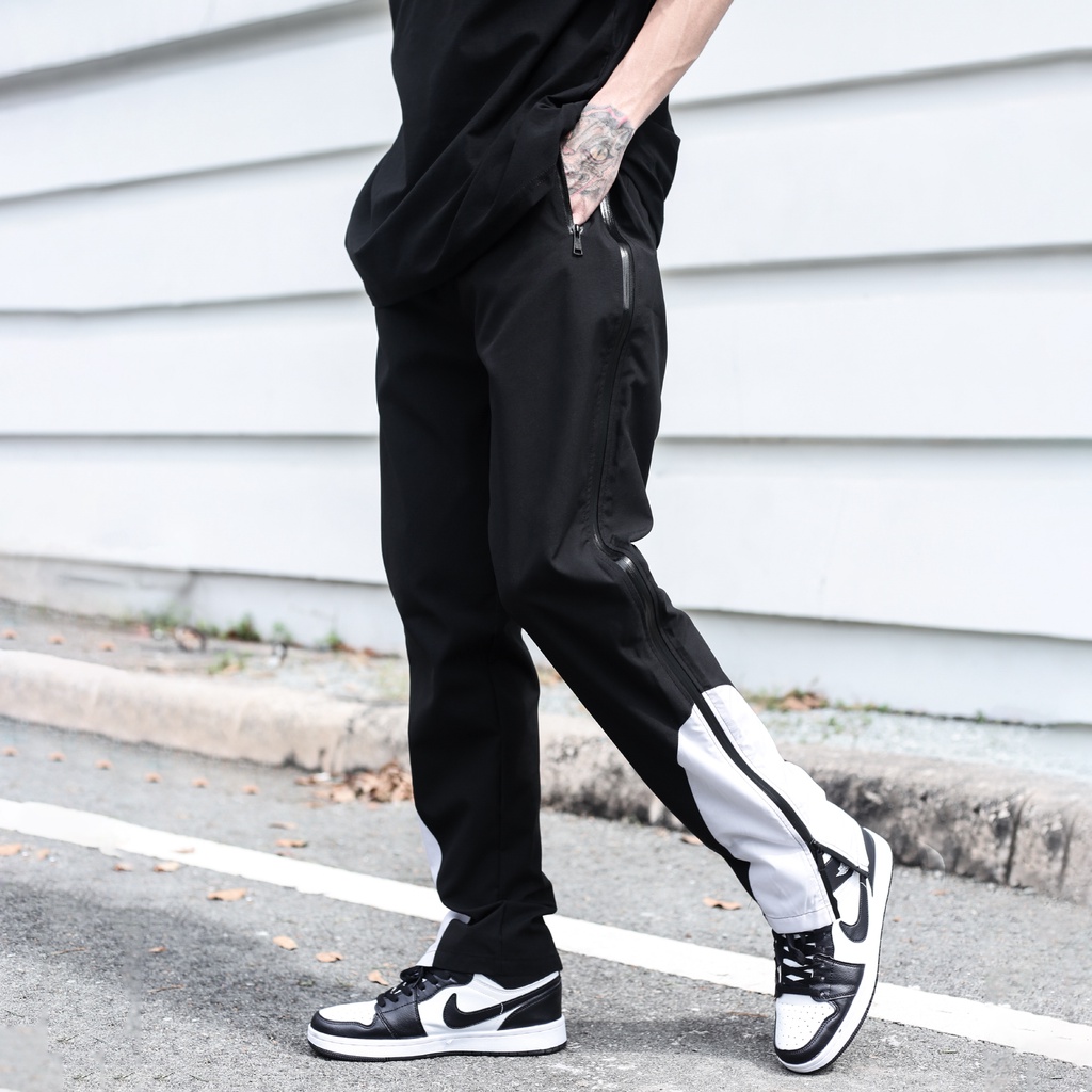 Quần Thun Có Zipper Khóa Sọc Trắng Chất Liệu Vải Dù Ống Rộng Form Unisex Màu Đen