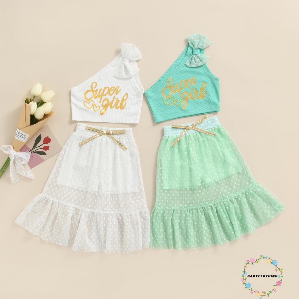 BBCQ-Áo croptop trễ vai thắt nơ in chữ + chân váy xòe lưới chấm bi thời trang cho bé gái