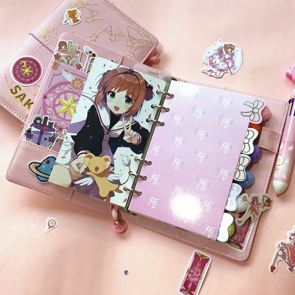 Sổ tay khổ A6 màu hồng in hình phong cách anime Sakura Thủ Lĩnh thẻ Bài Nhật Bản chất lượng cao