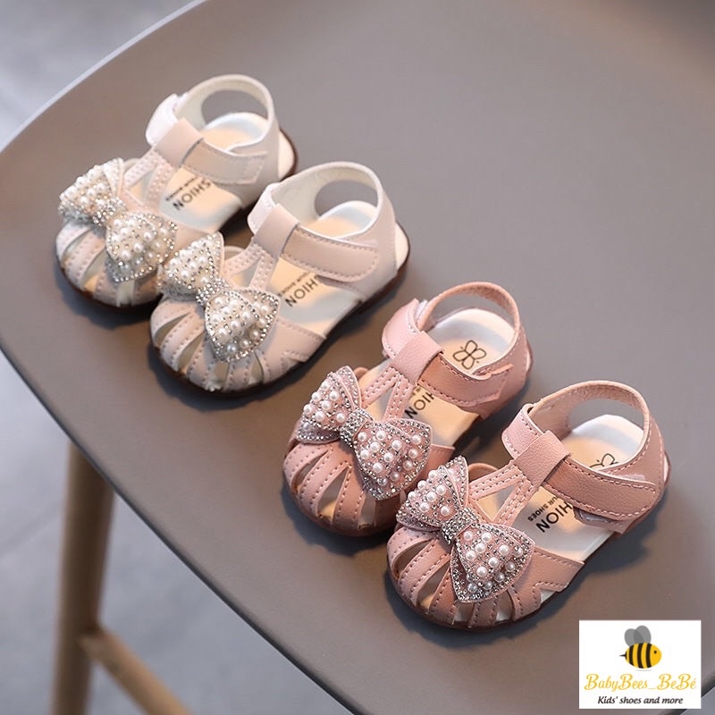Sandal quai rọ tập đi cho bé gái, dép quai hậu đính nơ có kim sa lấp lánh cho bé từ 0 đến 4 tuổi, 2 màu trắng - hồng a10