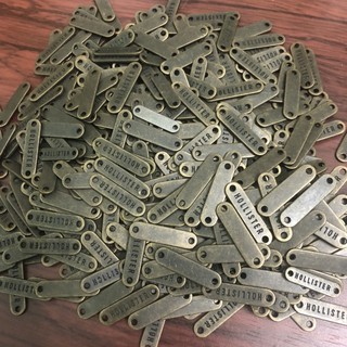 Túi 50 Nhãn Tên Hollister Đồng 2 Lỗ 2 Size Lớn/Nhỏ Hàng Công Ty