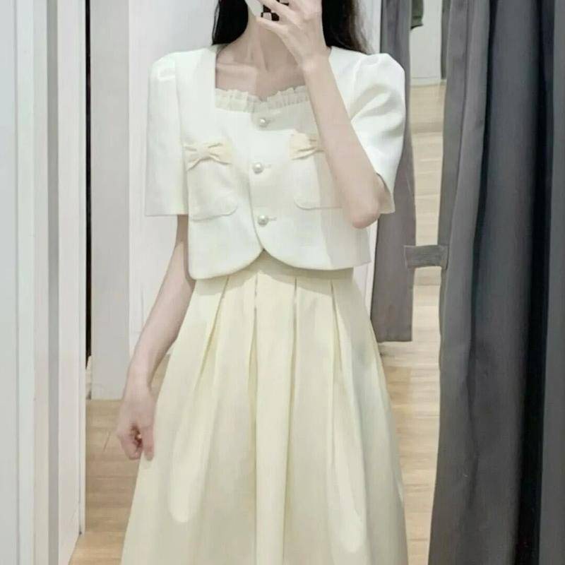 Set Áo Sơ Mi Trắng Cổ Vuông Tay Ngắn + Chân Váy Dài Xếp Ly Phối Túi Đính Nơ Xinh Xắn