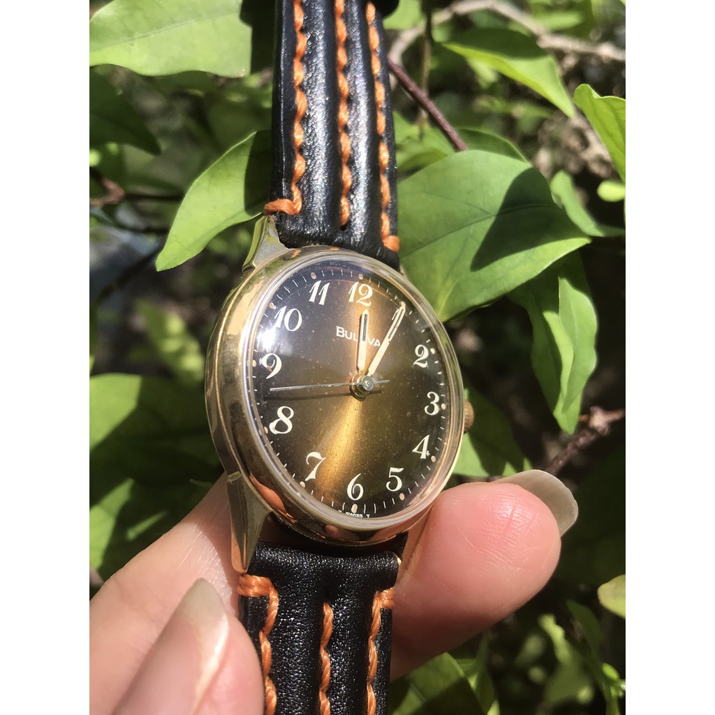 Đồng hồ nữ BULOVA cơ lên cót tay, máy vàng, mặt màu trà, niềng lắc kê vàng, dây da