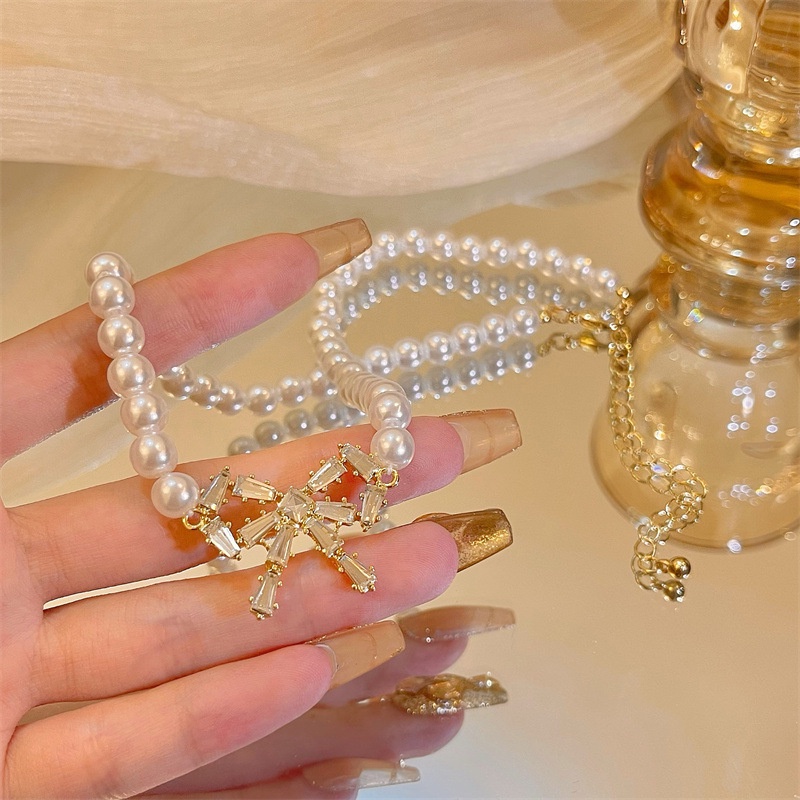 dây chuyền choker nữ chuỗi ngọc đính nơ sáng lấp lánh