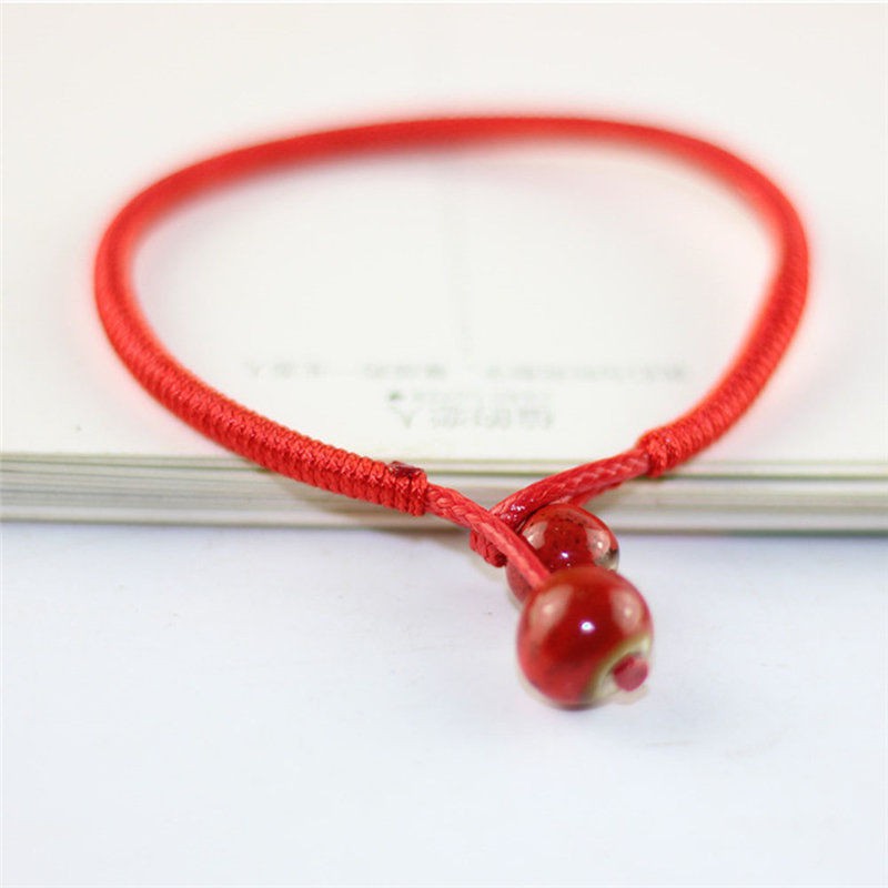 Vòng chỉ đỏ đeo tay dây bện đồng tiền vàng mang lại may mắn | BigBuy360 - bigbuy360.vn