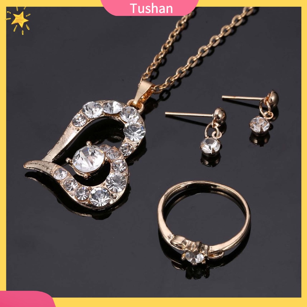 Bộ nữ trang gồm vòng cổ mặt trái tim bông tai và nhẫn đính đá pha lê sang trọng