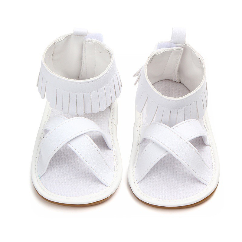 Giày sandal da PU màu trơn quai đan chéo phối tua rua đáng yêu cho bé gái