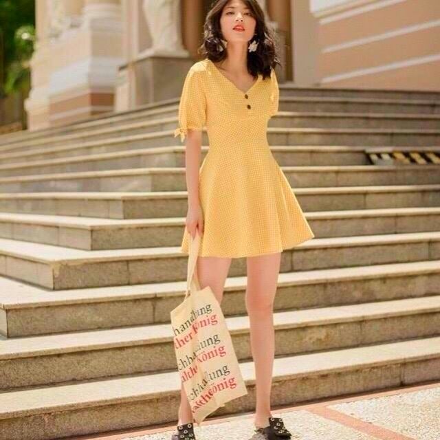 Đầm kate caro xòe cổ chữ v đính nút tay ngắn thắt nơ màu vàng