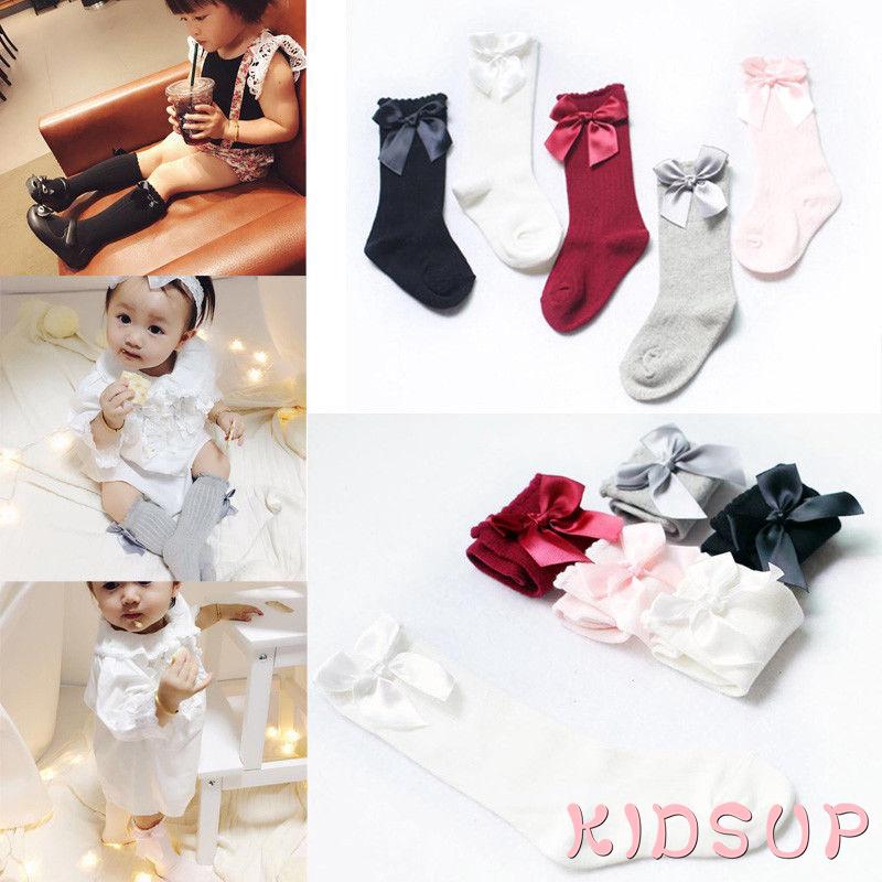 Đôi tất cotton dài mềm mại màu trơn trang trí nơ bướm xinh xắn cho bé gái