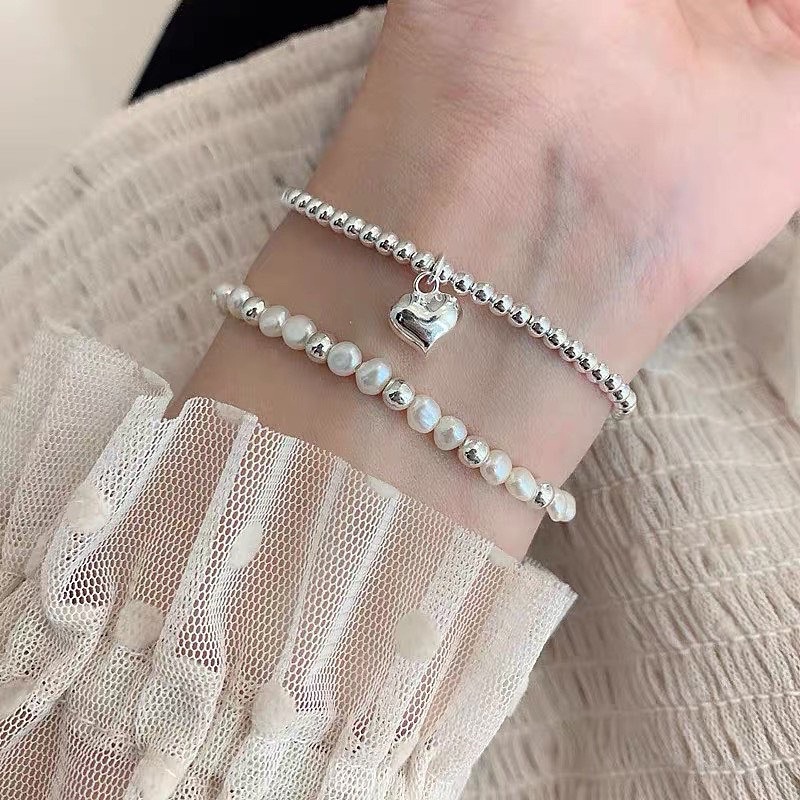 Vòng tay dây cước charm mạ bạc ngọc trai nhân tạo