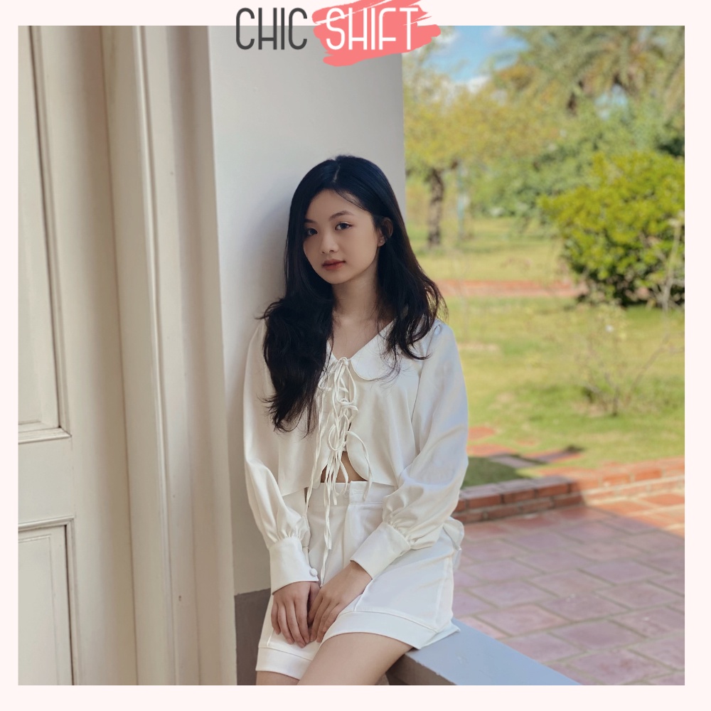 Áo sơmi nữ dài tay cột nơ cách điệu màu đen và trắng vạt áo lượn sóng mặc đi học, đi chơi - Chicshift