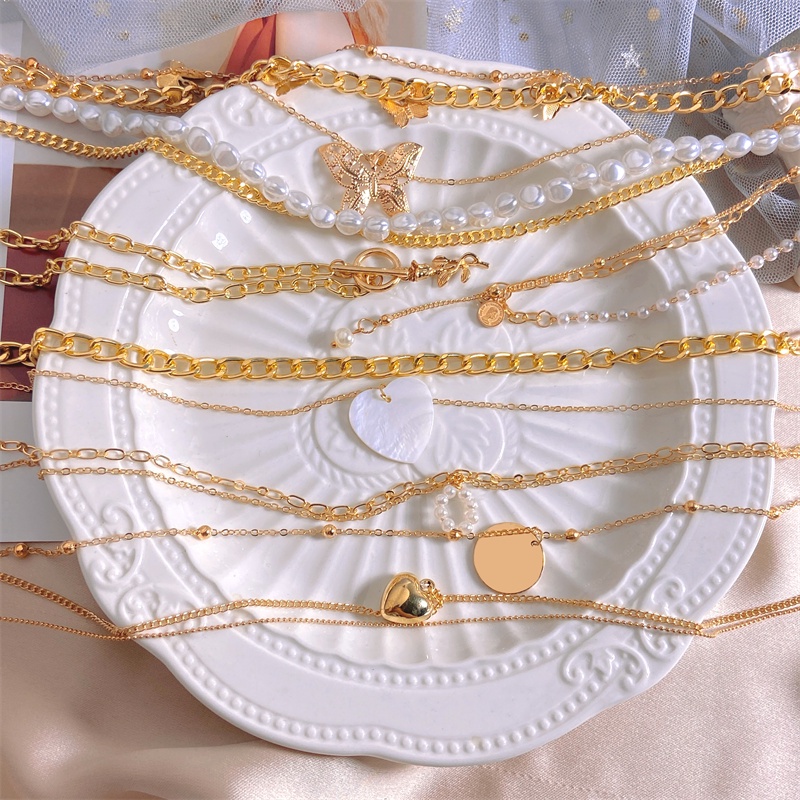 Vòng cổ dây xích rắn vàng nhiều lớp gắn ngọc trai và hình bướm trăng trái tim thời trang cho nữ