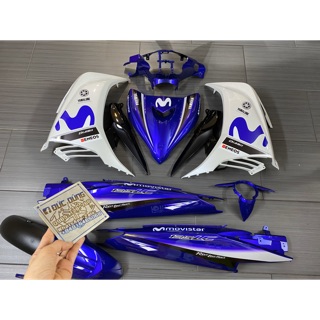 Áo Ex 135 xanh trắng tem Movistar