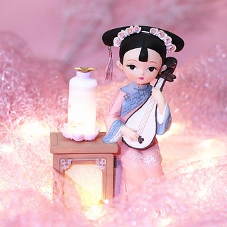 Tượng thiếu nữ cổ trang đánh đàn bên đèn