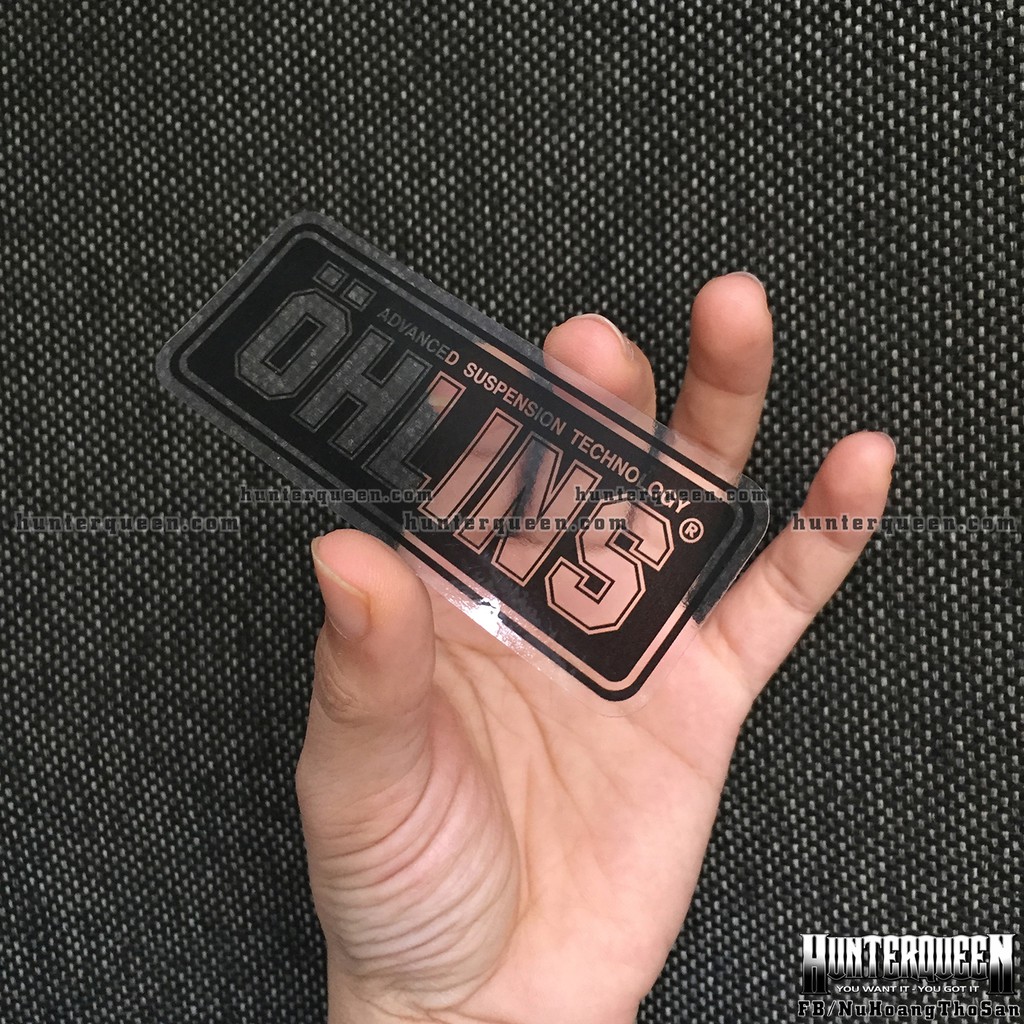 Logo. Oh-Lins[9x3.7cm] trong suốt. Nền đen, chữ xuyên thấu. Hình dán decal siêu dính, chống nước, tem đua trang trí