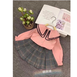 Set áo viền đen chân váy caro cho bé gái