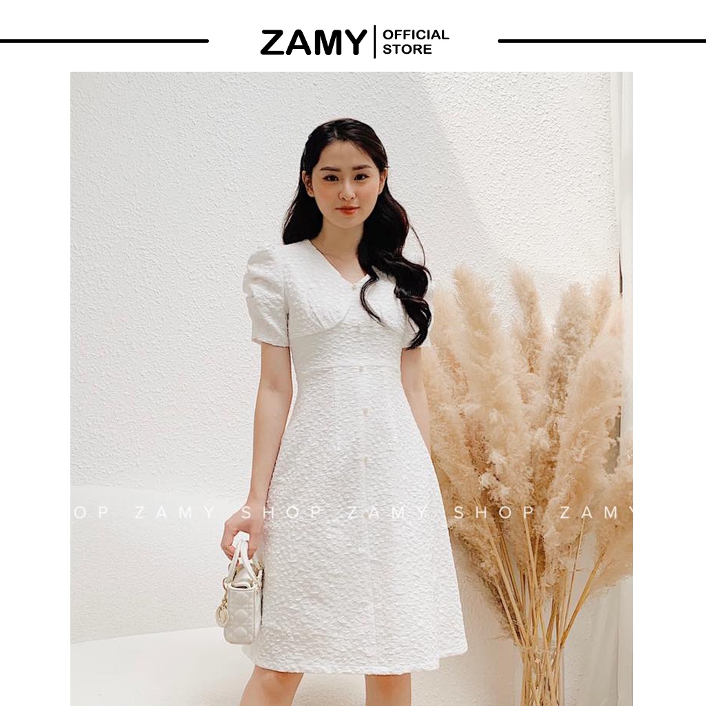 Váy/Đầm ZAMY chất vải xốp với thiết kế tay bồng và hàng ngọc được đính dọc theo váy phù hợp cho cả đi tiệc và đi làm.
