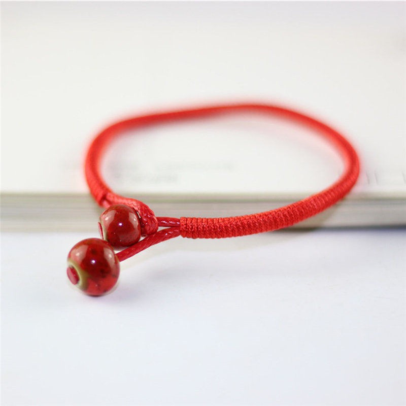 Vòng chỉ đỏ đeo tay dây bện đồng tiền vàng mang lại may mắn | BigBuy360 - bigbuy360.vn