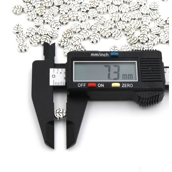 Bộ 50 Hạt Charm Hình Lá 7mm Bằng Kim Loại Màu Bạc Tây Tạng Dùng Làm Trang Sức DIY