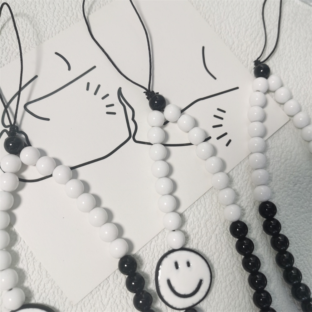 Dây Đeo Điện Thoại Acrylic Màu Đen Hình Mặt Cười Nhiều Màu Chống Thất Lạc