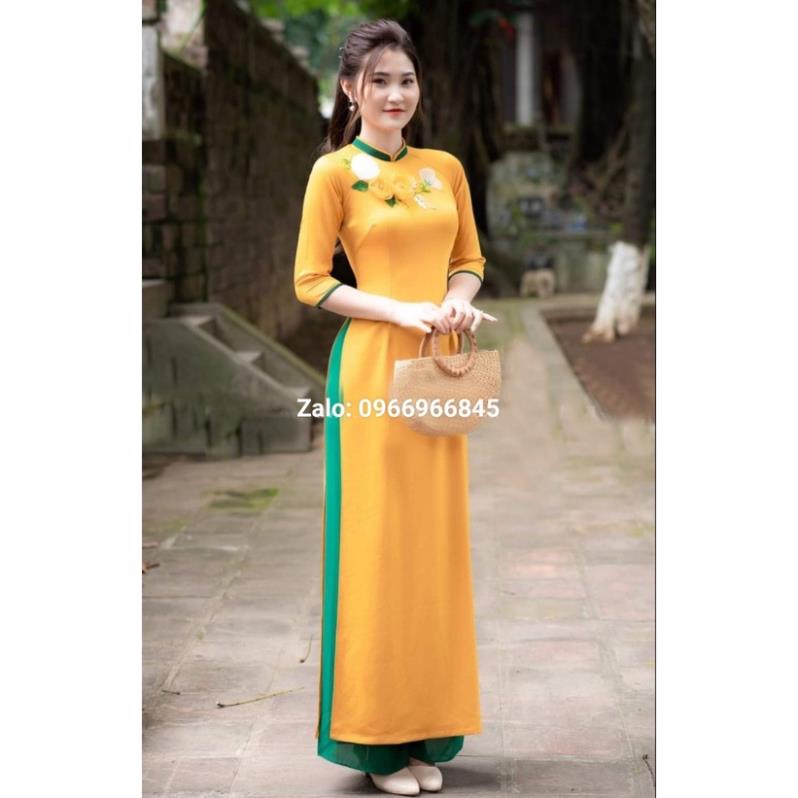 Áo dài màu vàng kết hoa ruy băng, may cách điệu né cor nổi bật, trẻ trung