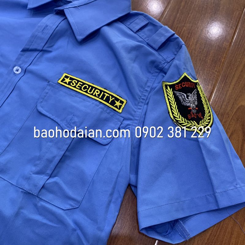 Quần áo bảo vệ màu xanh cộc tay kèm logo tay ngực (quần casme, áo vải xi)