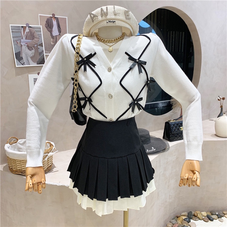 Set áo len trắng nơ và chân váy đen xếp ly 2 tầng cho nữ