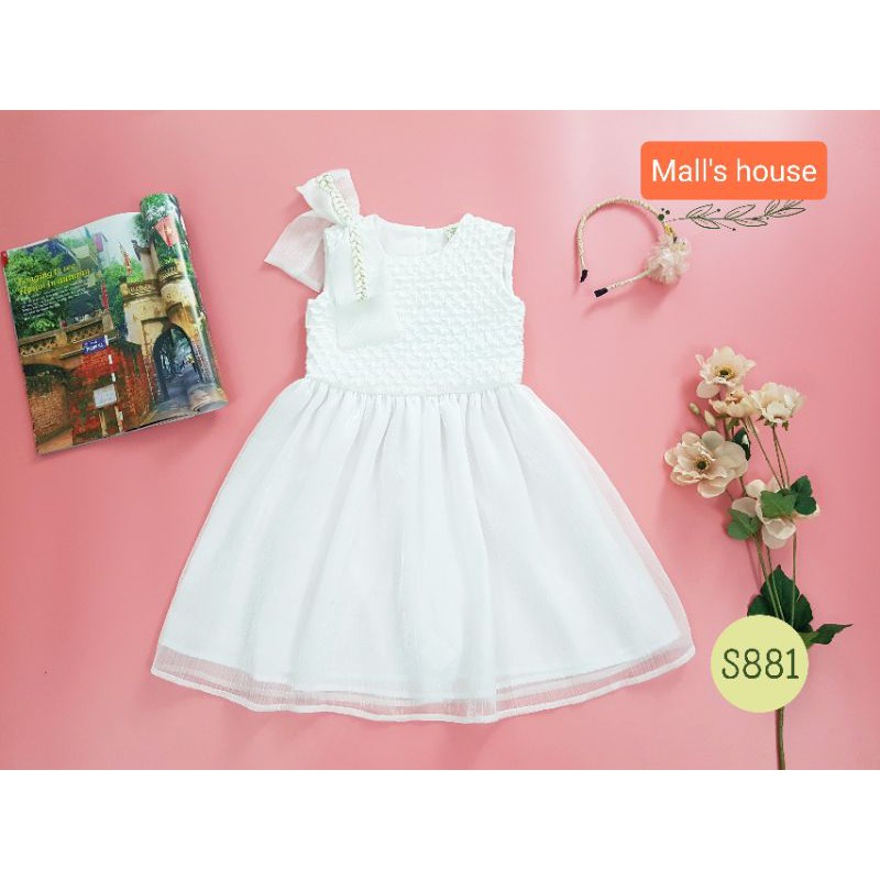 Váy OLI RIVER KIDS màu trắng đính nơ lệch siêu cute dành cho bé yêu