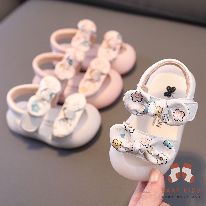 Sandal tập đi chống vấp phối nơ hình Bông hoa mũi có đế chống trơn trượt kiểu dáng Hàn Quốc mới nhất M865