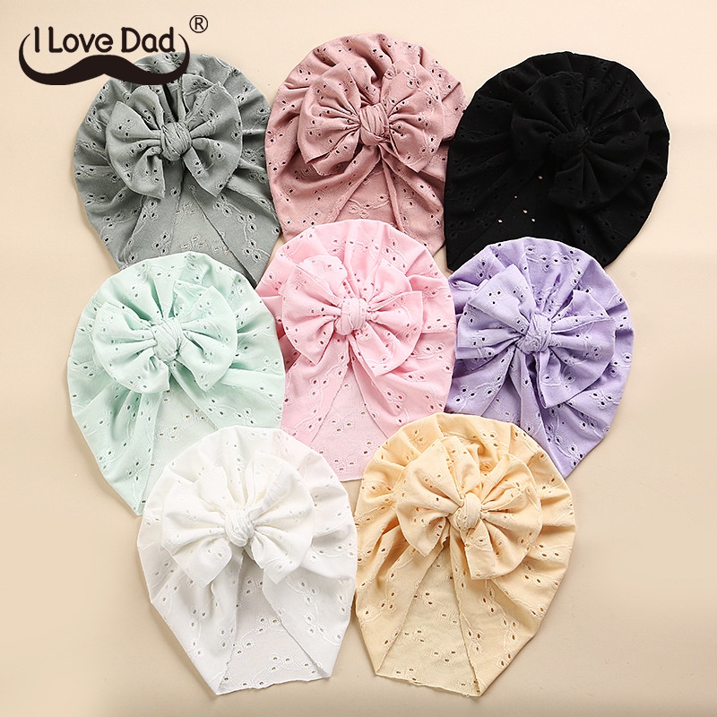 Mũ beanie mềm mại co giãn thoáng khí màu trơn đính nơ thiết kế dễ thương cho bé gái sơ sinh