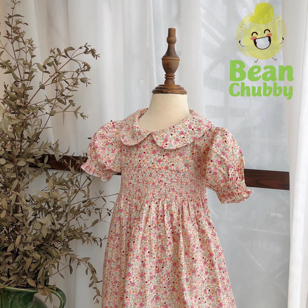 Đầm smock ngực hoa nhí cổ sen bé gái