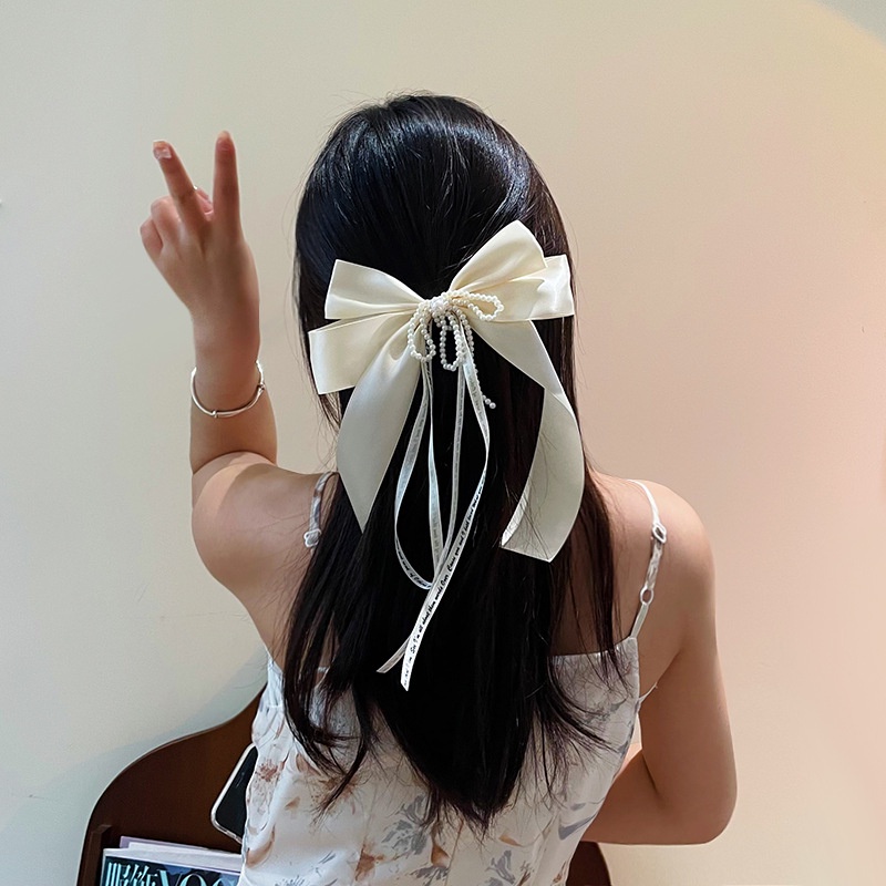 Kẹp tóc cài lông đuôi hươu đen với viền ngọc trai