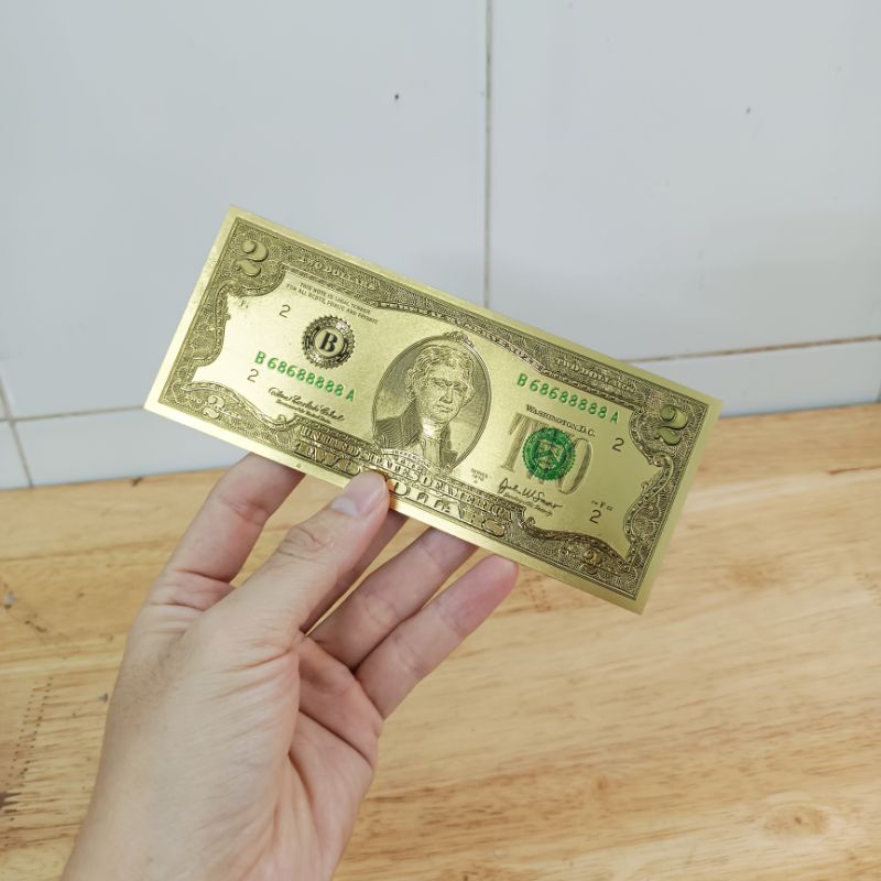 Tờ đô nhựa vàng ánh kim làm quà lì xì may mắn