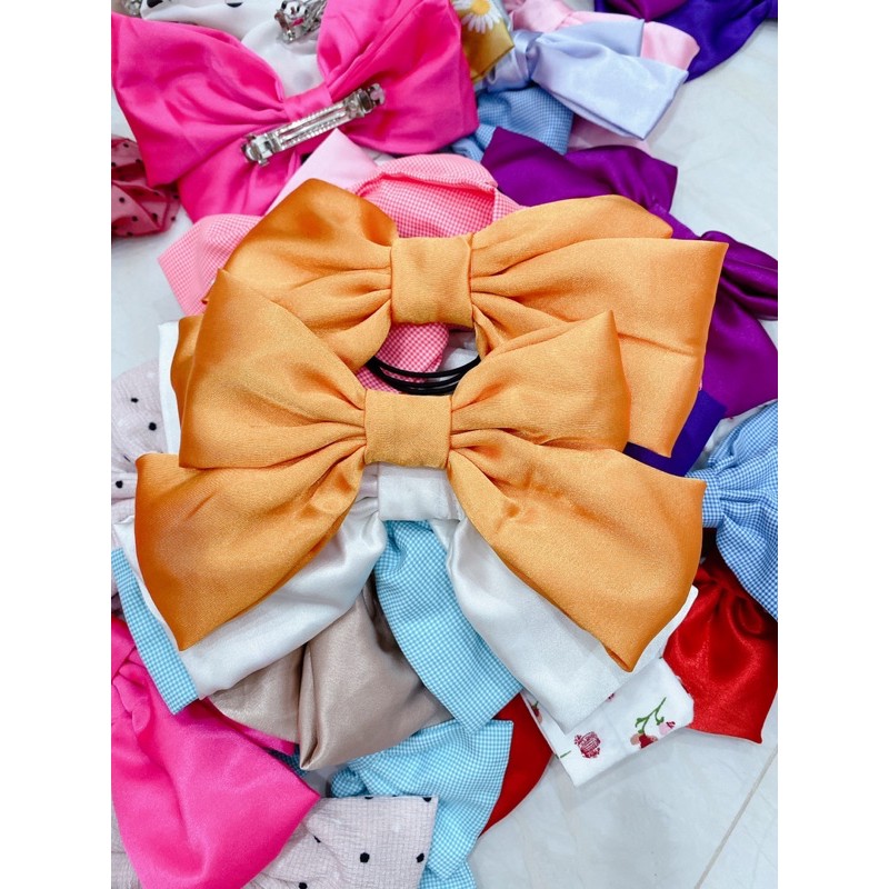 kẹp cột nơ màu cam