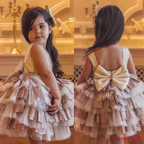 Đầm xòe hở lưng thiết kế xếp tầng phối nơ cho bé gái