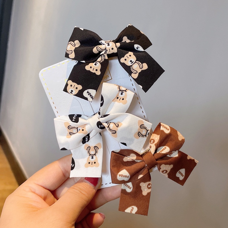 Kẹp tóc hình nơ màu đỏ sữa cà phê xinh xắn cho bé gái