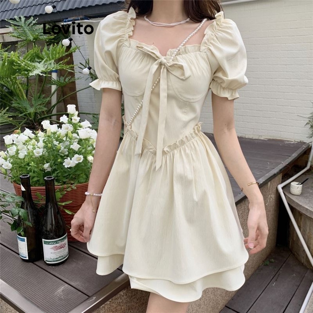 Đầm LOVITO tay phồng viền gợn sóng xếp nếp thắt dây trước màu trơn thường ngày dành cho nữ LNA02093 (màu trắng ngà)