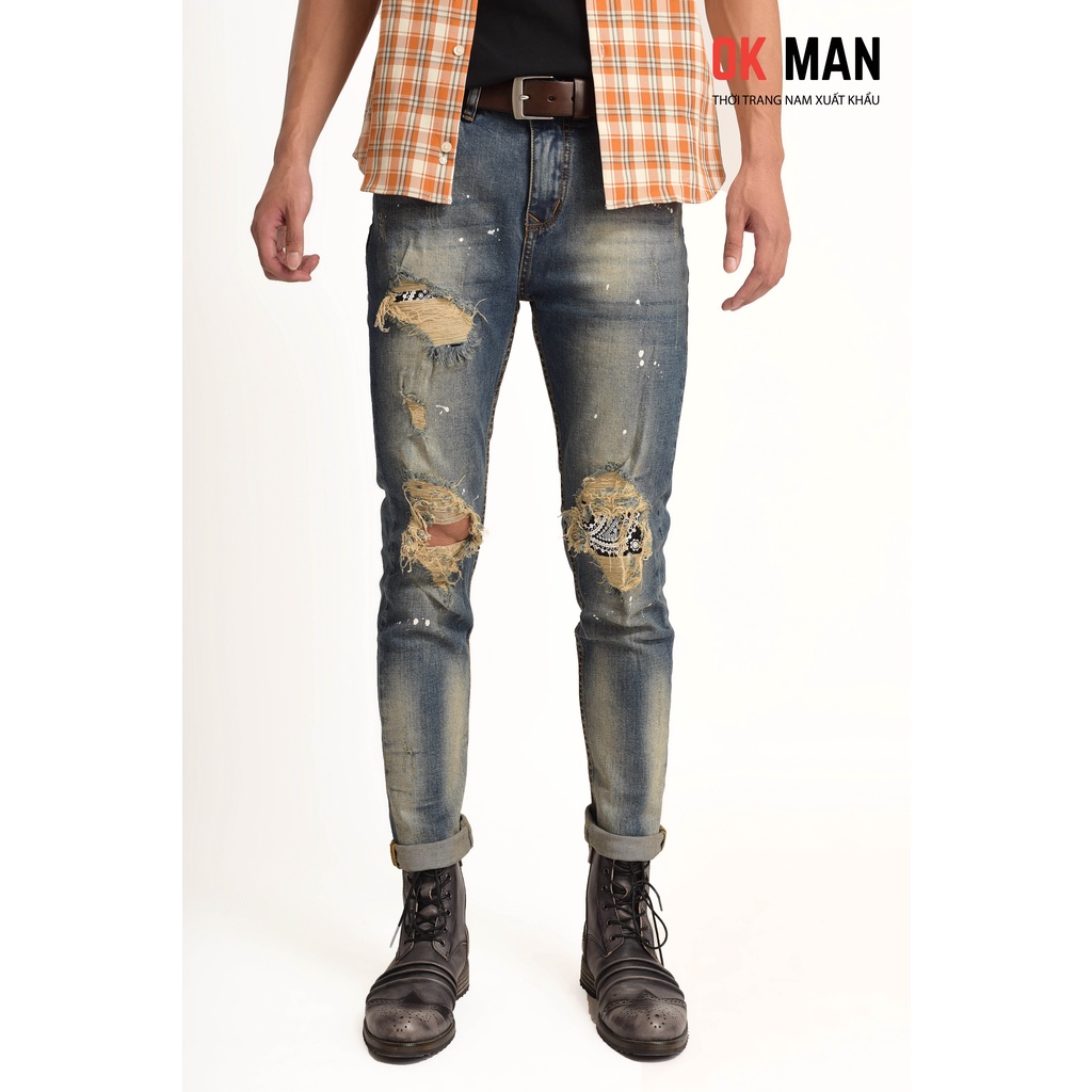 Quần jean nam rách, form slimfit, màu xanh cổ điển, vẩy sơn, co giãn tốt OkMan