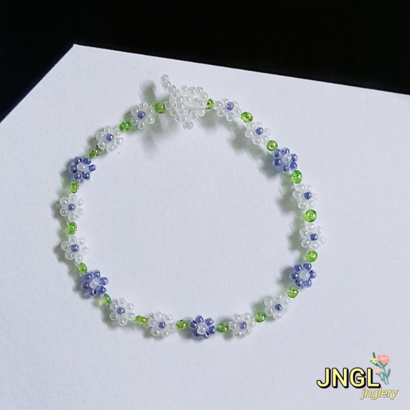 Vòng tay hạt cườm gạo kết hoa màu tím mã TK501