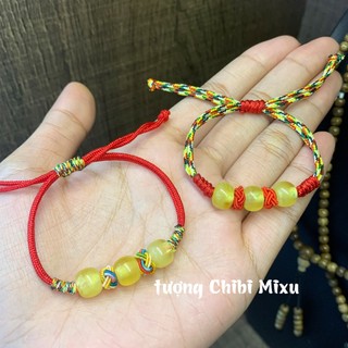 Vòng tay hổ phách mật lạp tết dây ngũ sắc cho bé