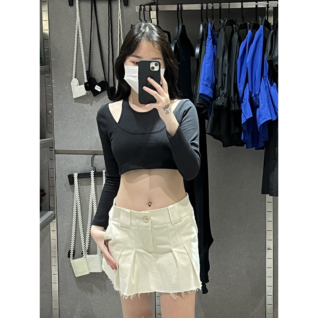 Chân váy xếp ly khaki form eo cạp thấp dưới rốn màu kem, là min - RAW CUT PLEATED MINI SKIRT - CREAM