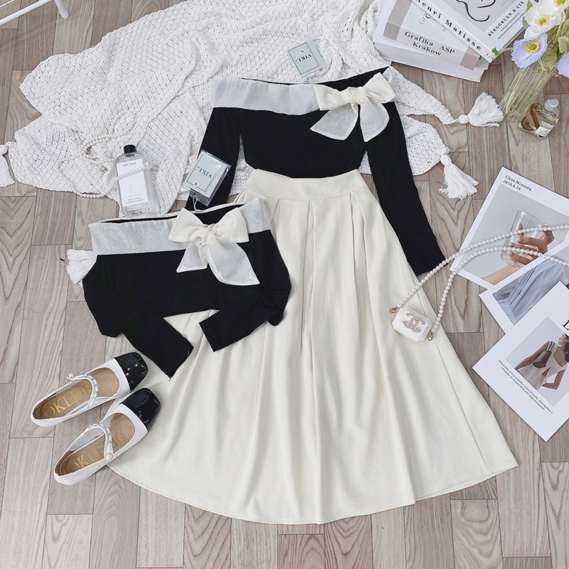 Sét Áo Đen Len Tăm Trễ Vai Nơ Phối Chân Váy Be Dài Xếp Li