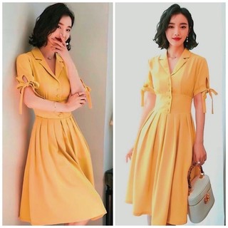 Đầm vàng nghệ tay nơ