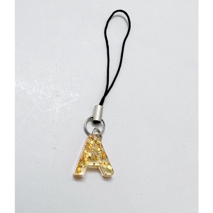Móc khóa dây chữ cái nhũ vàng keo epoxy trong suốt