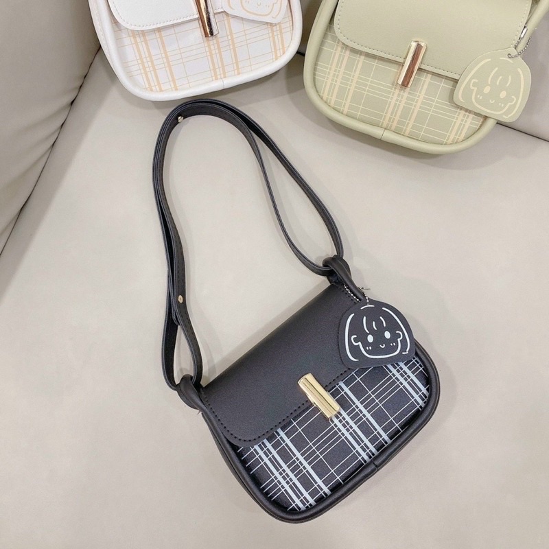 Túi đeo chéo, túi khoá kẹp nắp vát phối đường kẻ kèm móc treo mặt cười cô gái siêu dễ thương cho nữ