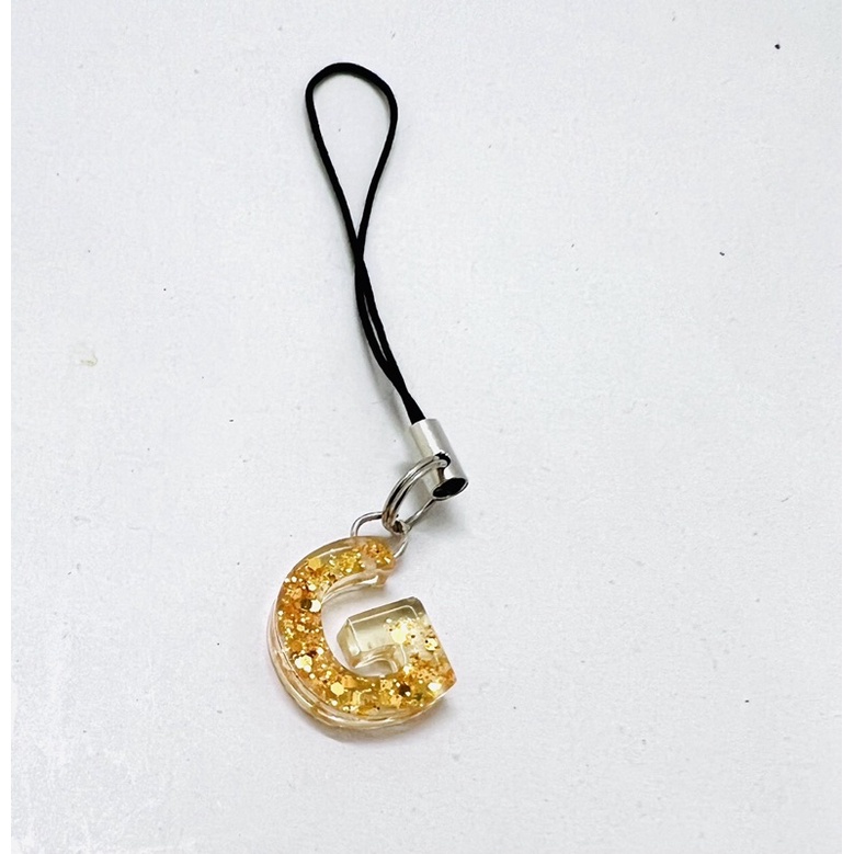 Móc khóa dây chữ cái nhũ vàng keo epoxy trong suốt