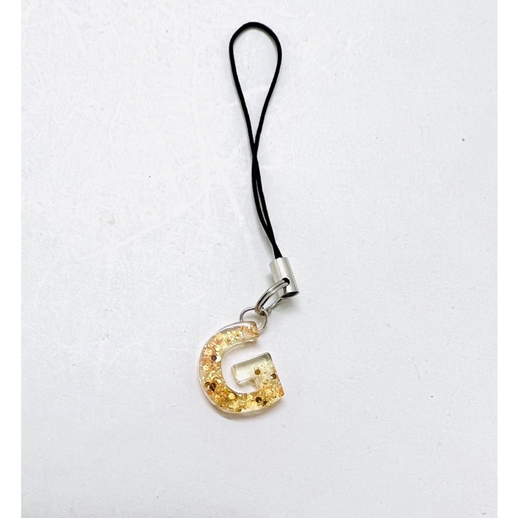 Móc khóa dây chữ cái nhũ vàng keo epoxy trong suốt