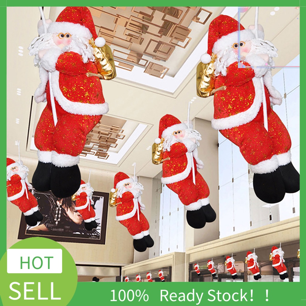 Ông Già Noel Đang Leo Dây Trang Trí Cây Thông Noel